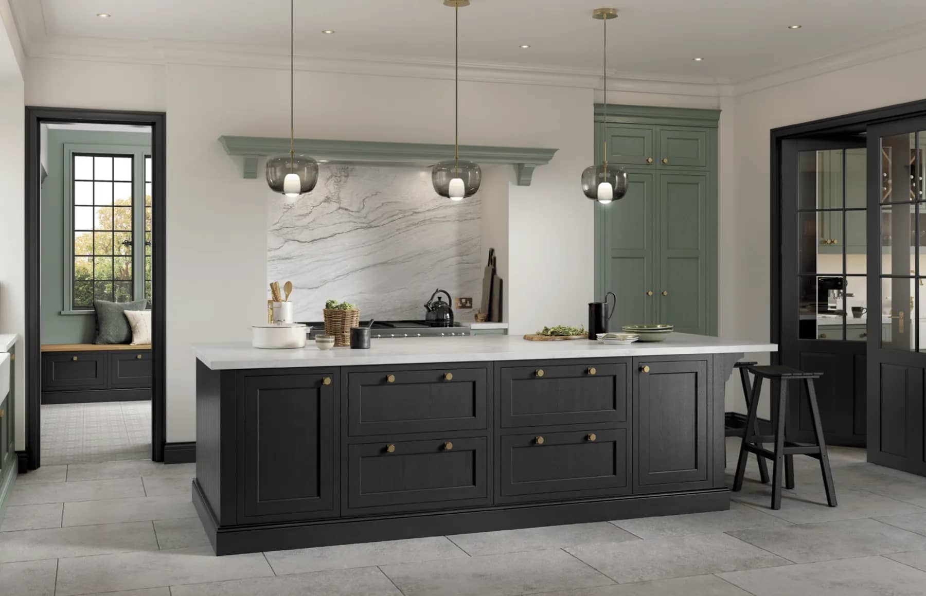 Charcoal in-frame kitchen island under glass pendants, with sage green tall pantry units and a marble splashback.