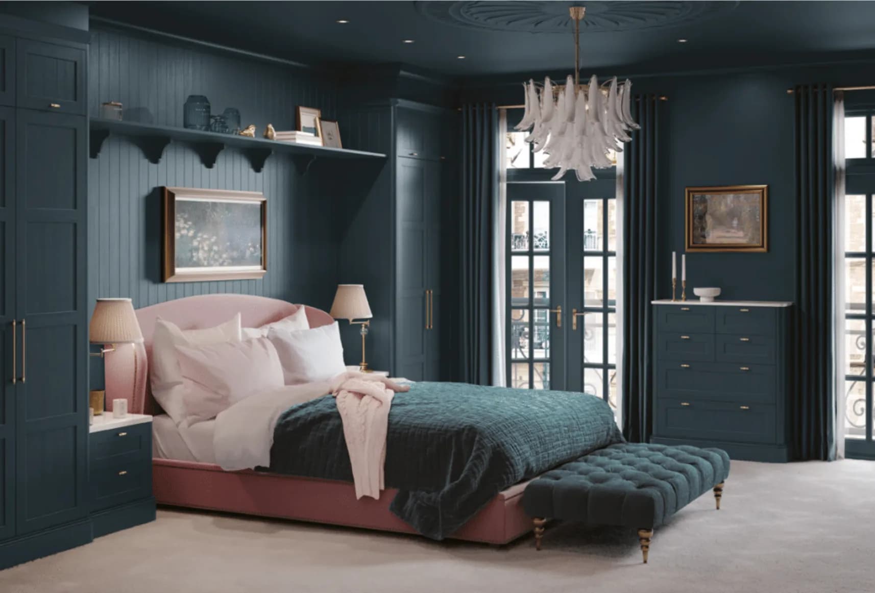 A deep teal bedroom fitted wall to wall: wardrobes to the cornice on both sides of the bed, a bracketed shelf over the headboard and a matching chest of drawers