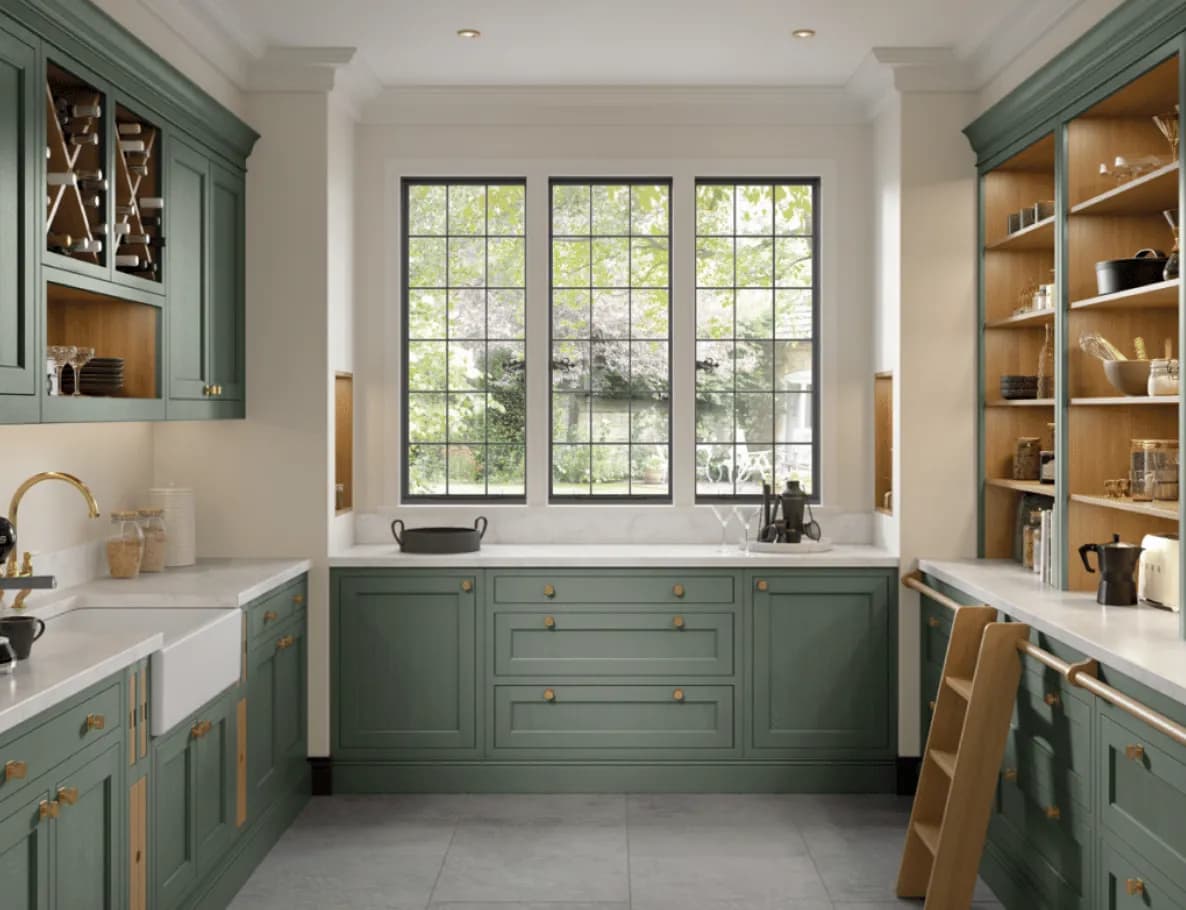 Fitted pantry in sage green with open oak shelving, a butler sink, marble worktops and a library ladder