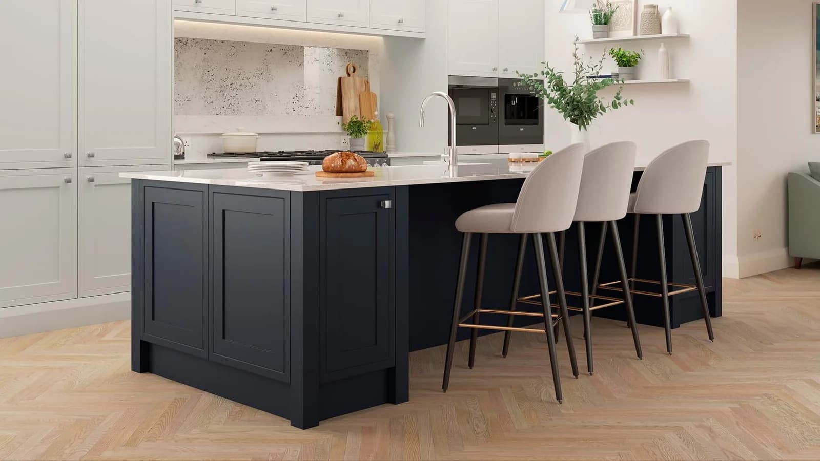 Pale oak herringbone boards running under a navy painted island and past three stools